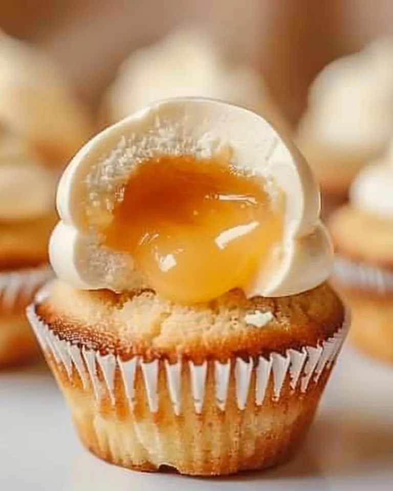 Honey Peach Cream Cheese Cupcakes topped with fresh peach slices
